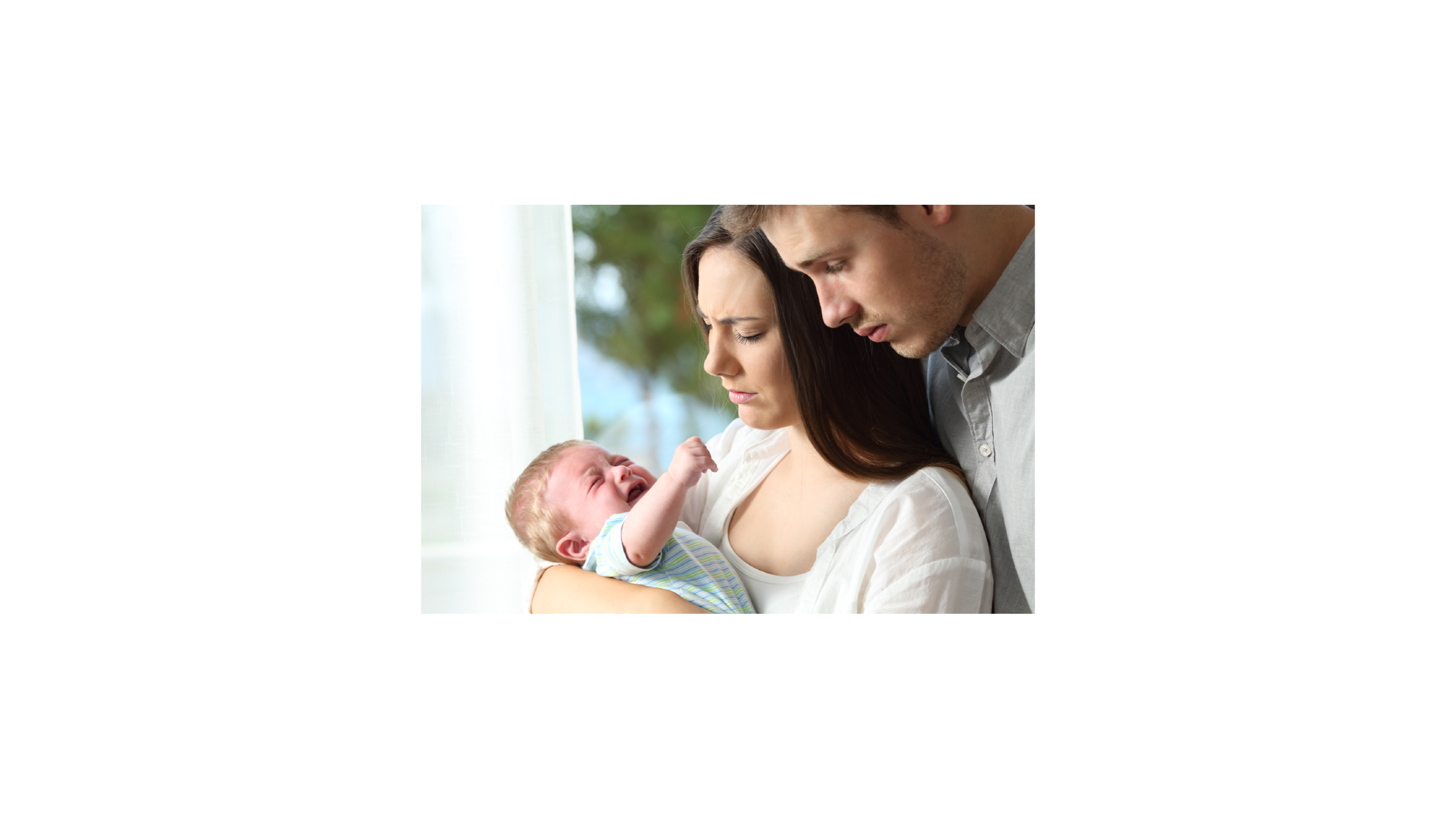 Worried parents holding their crying baby